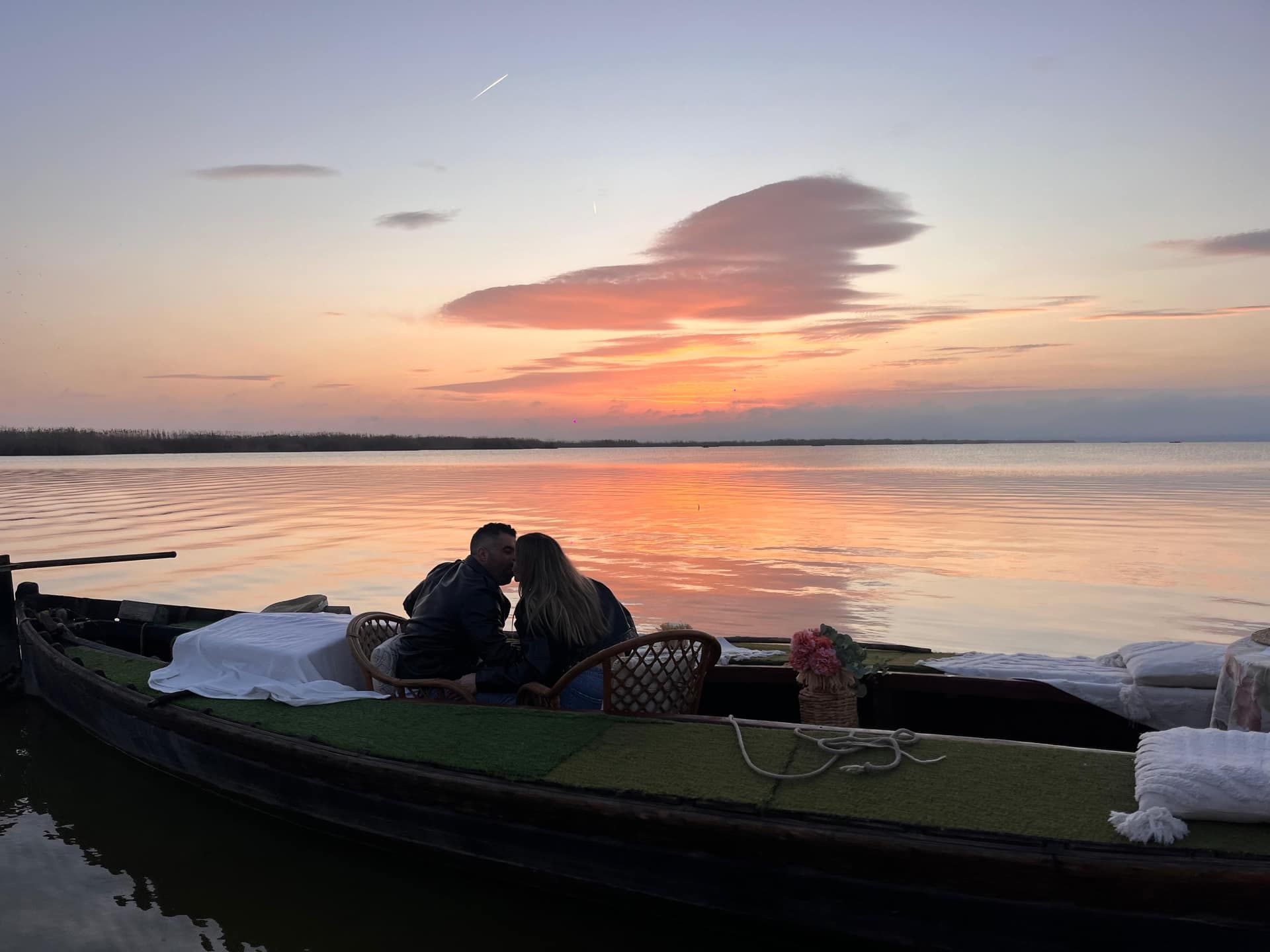 Pareja viendo la puesta de sol desde una barca en la Albufera de Valencia