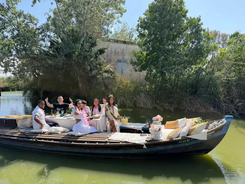 Grupo celebrando en barca decorada con flores en canal de la Albufera Valencia